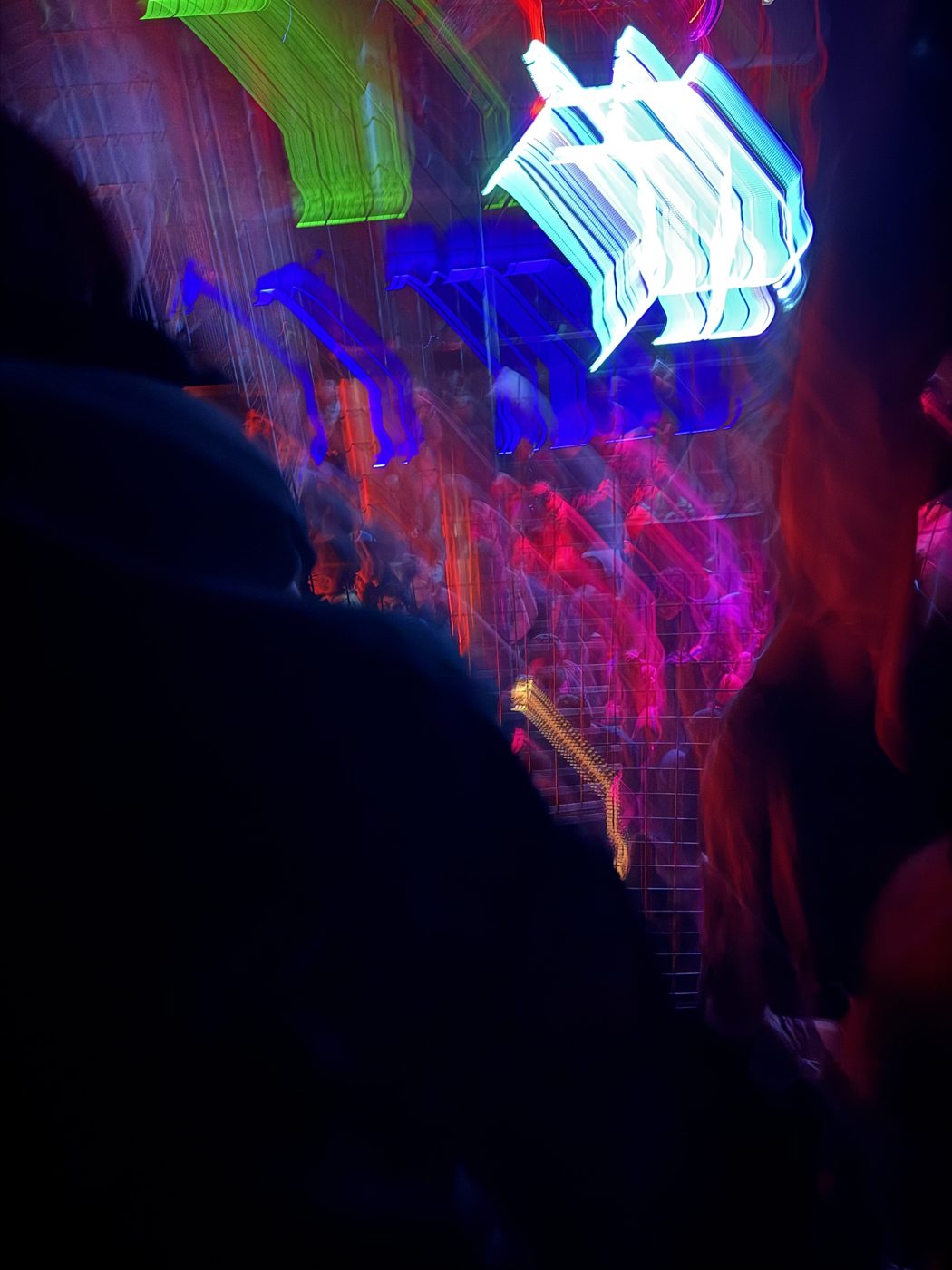 Blurred club lights over a crowd
